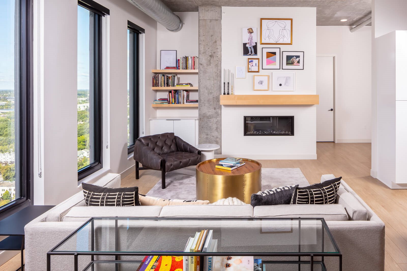 Penthouse living room with built-in shelving and fireplace